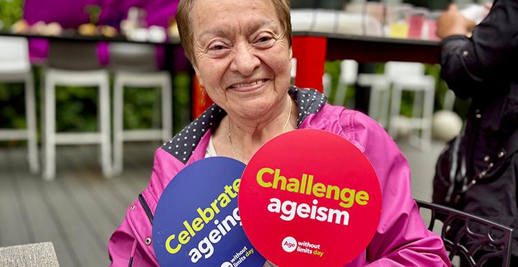One of the attendees holding up a Challenge Ageism sign
