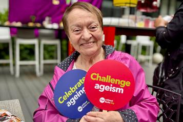 One of the attendees holding up a Challenge Ageism sign